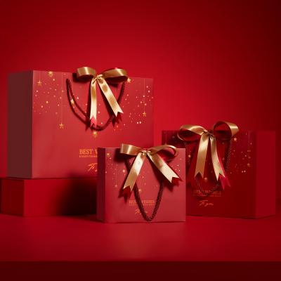 China Customized Printed Red Christmas Paper Bags with Ribbon Bow for sale