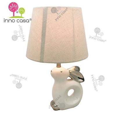 China Novelty Ceramic Porcelain Fabric Shade Rabbit Kids Table Lamp Low Bedside Light With Silver Electroplating for sale