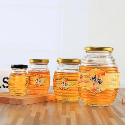 China Freshness Preservation Wholesale lower price different sizes glass bottle for honey/biscuit/jam packing with spiral pattern and lid for sale