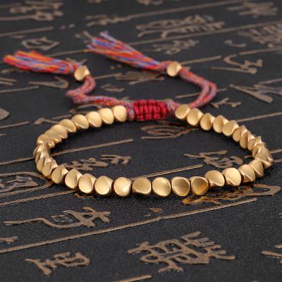 China Environmentally Friendly Wholesale Handmade Braided Adjustable Red Multi Color String Gold Plated Tibetan Buddhist Beads Irregular Copper Luck Bracelet for sale