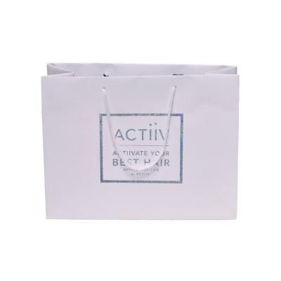 China Recycled Materials Art Paper Gift Packaging Bag Custom Printed Luxury Retail Paper Goods Shopping Paper Bag for sale