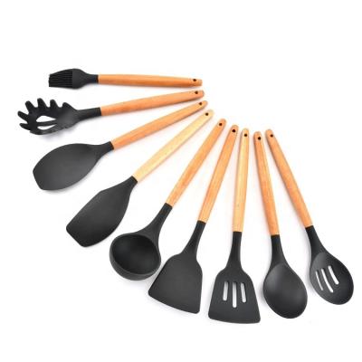 Cina Amazon top seller silicone cooking utensils 11pcs Kitchen Tools Silicone Set wood handle in vendita