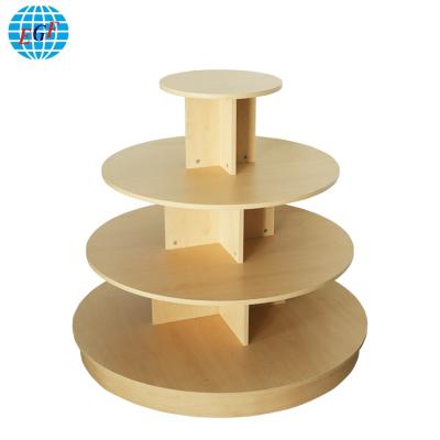 China Round Commercial Wood Top 4 Tiered Clothing Display Retail Round Table for sale