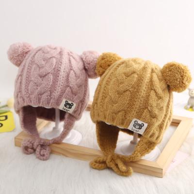 China XUFANG New Arrival Fashion Kids Winter Hats COMMON Beanies Winter Solid Color Warm Earflap Knitted Hat With Pom Pom for sale