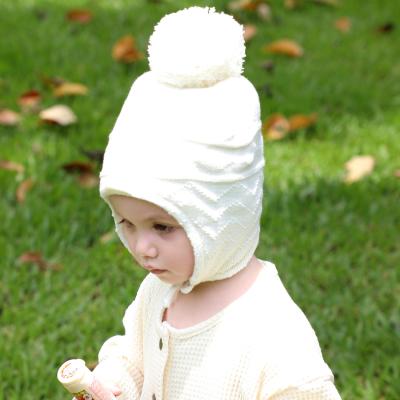 China XUFANG Fashion JOINT Autumn Winter Toddler Boys Girls Crop Striped Knitted Hats Winter Warm Earflap Kids Winter Hats With Pom Pom for sale