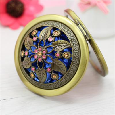 China Hot Products Travel Mini Pocket Compact Make Up Mirror Portable Lighted Gemstones Flower Shapes Bronze Round Folding Makeup Mirror for sale