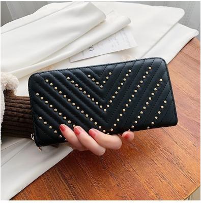 China Solar panel 2022 spring European style new ladies and American long wallet solid color rivet wallets for sale