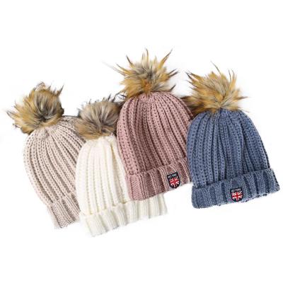 China COMMON Outdoor Women's Winter Hat Caps Knitted Pom Pom Hat For Women With Woven Label for sale