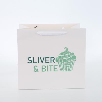China Custom Recyclable White Logo Ribbon Handle Gift Luxury Apparel Boutique Shopping Paper Bag for sale