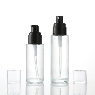 China Luxury Cosmetic Skin Care Cosmetic Packaging Shoulder Glass Flat Bottle With Black Lotion And Spray Pump for sale