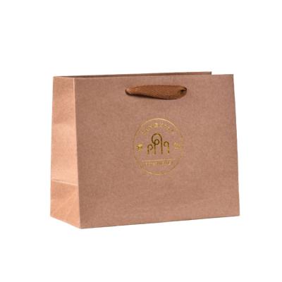 China Recyclable Promotional Bags and Travel Custom High Quality Gold Foil Stamping Kraft Paper Bag with Ribbon Handle Promotional Paper Bags for sale
