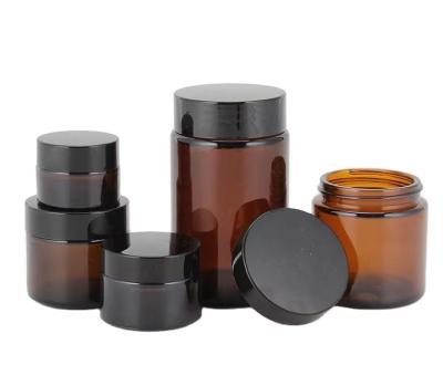 China Cosmetic Factory hot selling 5ml 10ml 20ml 30ml 50ml 60ml 100ml amber glass jar cosmetic jars with black silver gold lid for sale