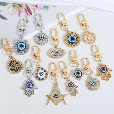 China Turkish Eye Key Chain 18k Gold Plated Ring Hamsa Palm Evil Eyes Key Chain Crystal Heart Evil Eyes Key Enamel Bag Blue Turkish Eye Pendant Key Chains for sale