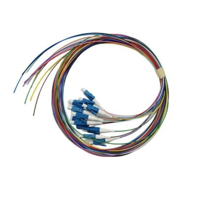 中国 0.9mm FTTH LC UPC カラーフルファイバー LSZH/PVC シングルモード SM 12コア 光ファイバーピグテール 販売のため