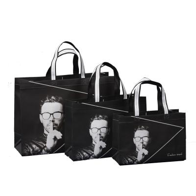 China Cotton Stain Fashionable Men's Clothing Handbags Men's Cloth Store Clothing Bags Nonwoven Handbags for sale