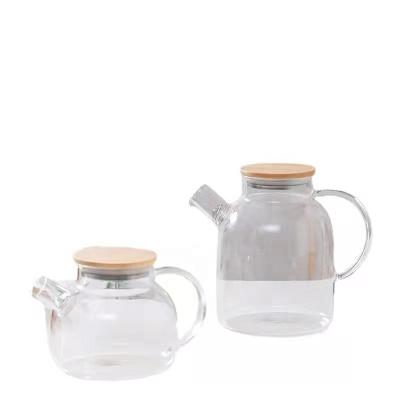 China Sustainable 1000 ml 34oz High Borosilicate Heat Resistant Glass Tea Pot with Handle and Bamboo Lid Tea Water Pitcher for sale