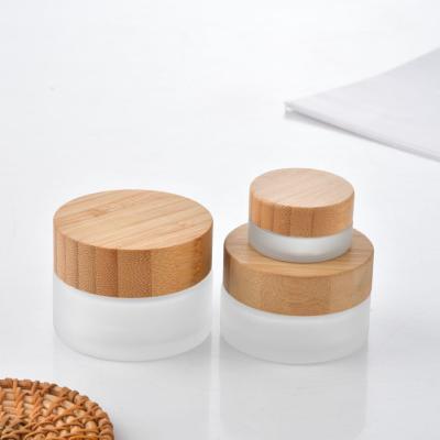 China Cosmetic Transparent Frosted Glass Jar Suppliers Round Bamboo Glass Jar Saffron Glass Jar for sale