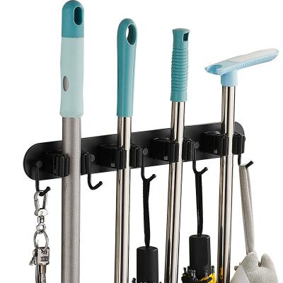 China Low MOQ Bathroom Kitchen Broom Broom Tool Holder Durable Adhesive Household Storage Broom Holder Gray Black Mop Hanger for sale