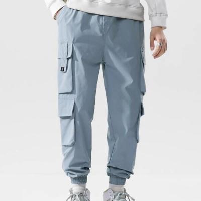 China Anti-Wrinkle Clothing Factory Wholesale Custom Casual Pants Letters Pocket Graphic Printed Mens Flap Cargo Pants for sale