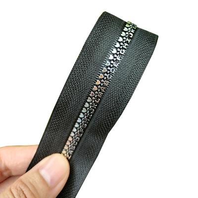 China Color Fade Proof Feature Good Quality No.5 Plastic Resin Zippers For Garment Letter Style Zips for sale