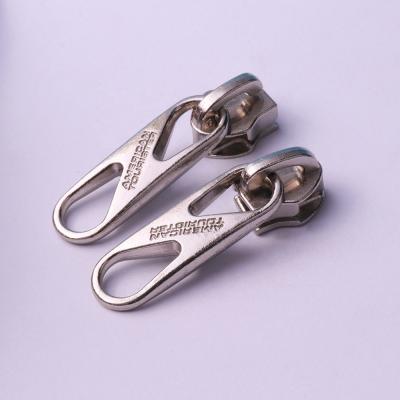 China Free Sample Nickel Free YUANXING Stamped Decorative Slider Puller Bold Explosion Proof Zipper Puller Slider for sale