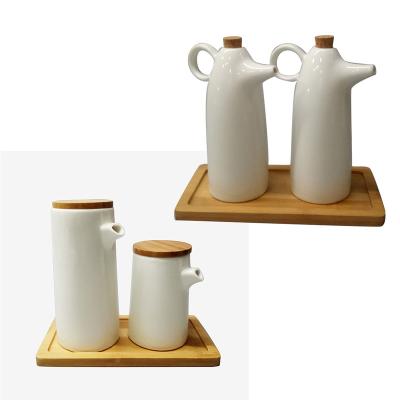 China Freshness Preservation Vinegar Oil Dispenser Bottle Kitchen Porcelain White Ceramic Condiment Set With Stand Dispenser Bamboo Bottle for sale