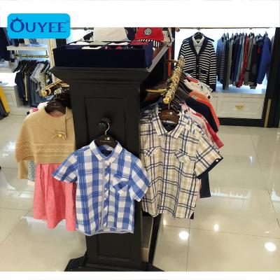 China Baby Store Clothes Shop Counter Table Design Baby Clothing Stores Baby Store Garment Display Rack for sale