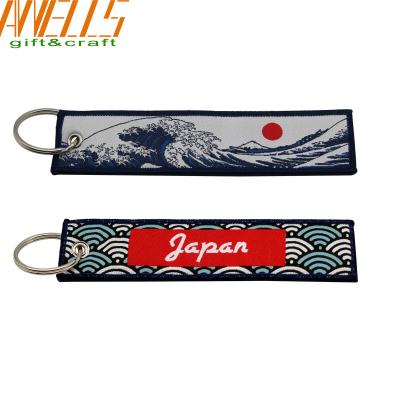 中国 割れ目リングおよびアイレットが付いている昇進の設計刺繍された生地キーホルダー 販売のため