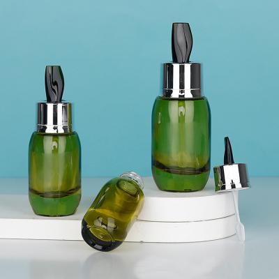 China Skin Care Serum Cream Bottles 15ml 30ml 50ml Clear Green Glass Designs with Stirring Stick Customizable for sale