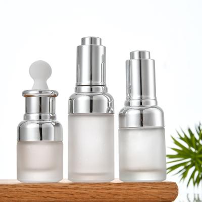 China Round Glass Bottle Alu Dropper Essential Oil Bottle with Box Customize Luxury Oil Push Button Flat Shoulder 20ml 30ml 50ml for sale