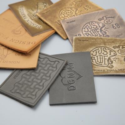 China Custom Fashion OEM TS CLOTHING Jeans Metal Label PU Leather Patch For Garment for sale