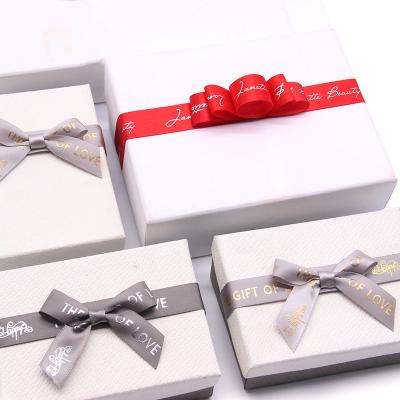 China Eco-friendly Customized Bow premade double sided tape rough satin ribbon bow with pritining LOGO for sale