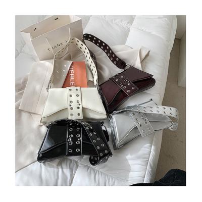 China Designer 2021 Fashion Hollow Strap Armpit Trapezoid Dumpling Shoulder Bags Clips Ladies Luxury Below Silver Handbags For Women for sale