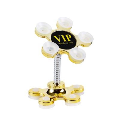 China Adjustable Sucker Holder For Mobile Phone 360 ​​Degree Rotatable Metal Flower Suction Cup Mobile Phone Holder Car Magic Bracket for sale