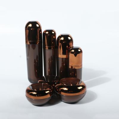 China Luxury Cosmetic Capsule Shape Brown Acrylic Container Sets 30/80/120ml Cosmetic Bottles 15/30/50g Plastic Jars for sale