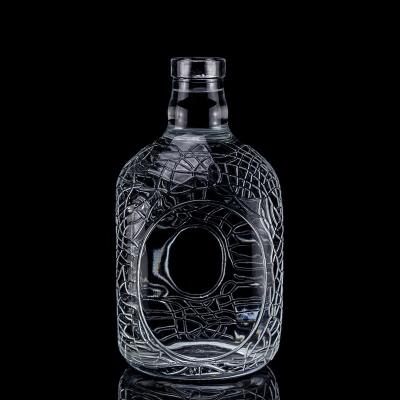 China Glass Round Carved 700ml 750ml Vodka Glass Bottle Wine Bottle With Cork Sealing Type for sale