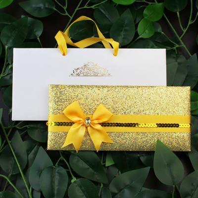 China China Handmade Luxurious Gold Folder Wedding Invitation Card Glitter Wedding Invitation With Guest Logo Hand Bag for sale