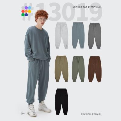 China Custom Logo 330G Weight Free Loose Fashionable Street Jogger Anti-Pilling Solid Color Ankle-tied Long Sports Trackpants for sale