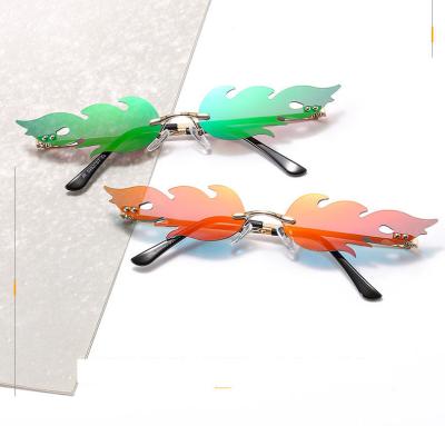 China Fashion Sunglasses Wholesale Rimless Flame Shape Charming Shades Fashionable Women's Sunglasses for sale