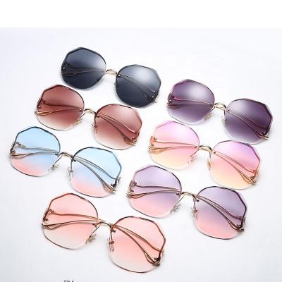 China Fashion sunglasses 2021 new small 400 shades round gradient UV rimless sunglasses for sale