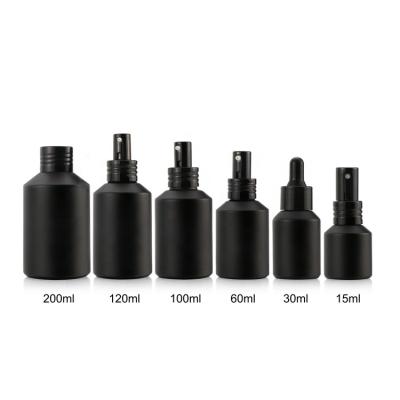 China Luxury 2oz Matte Black Cylindrical Spray Glass Bottle Lotion Essence Cream Bottle for sale