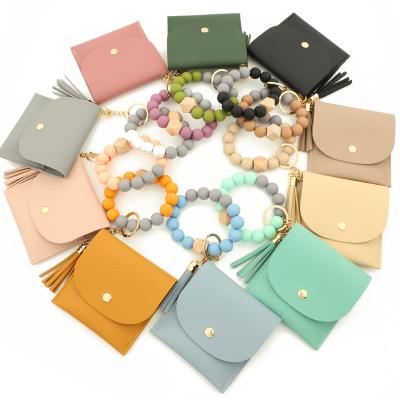 China Credit Cards Wooden Beaded Wallet Leather Wristband Bracelet Souvenir Gifts Tassel Women Silicone ID Key Chain Key Chain for sale