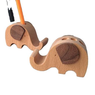 China Wholesale Eco-friendly Solid Wooden Mobile Phone Holder Multifunctional Elephant Beech Cell Phone Wooden Base for sale