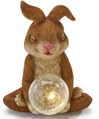 China Solar Powered Yoga Bunny Holding Crystal Ball Meditating Bunny Novelty Easter Garden Sculpture Polyresin Statue for sale