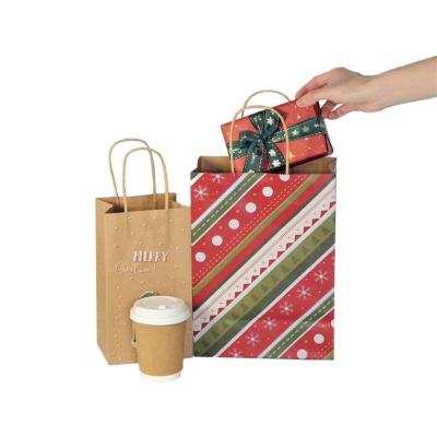 China Los bolsos del regalo de la Navidad del regalo del Año Nuevo reciclan Kraft CMYK impresos en venta