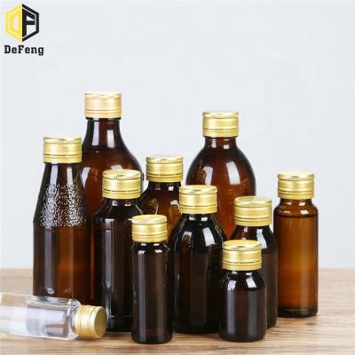 China Pharmaceutical Clear Amber Oral Liquid Glass Bottle With Metal Lid Medical Glass Bottle for sale