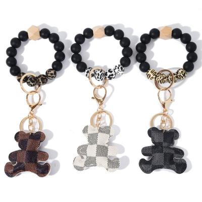 China Fashionable Silicone Leather Wooden Bead Keychain Bracelet Wholesale Keychain Bear Bear Key Chain for sale