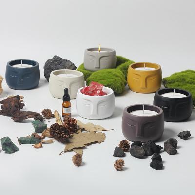 China Nordic modern unique custom tabletop home decoration color container candle shape face design ceramic candle jars for sale