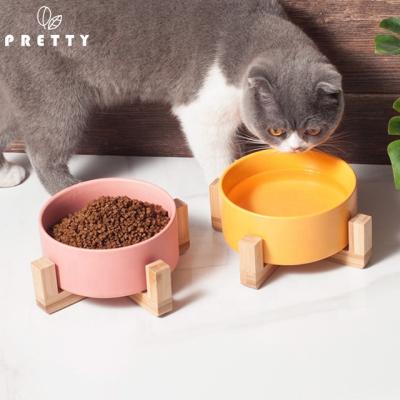 China Pretty Non-automatic Ceramic Cat Bowl With Stand White Ceramic Dog Bowl Food Bowl Durable Ceramic Raised Pet Cutlery With Wooden Stand for sale