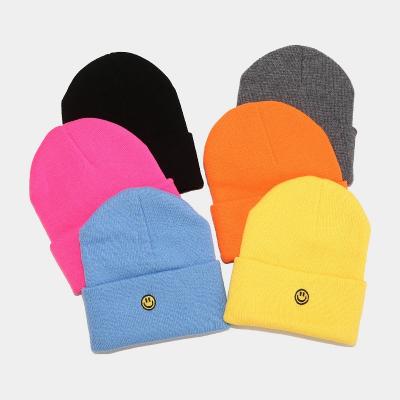 China New beautiful face embroidery hat men's and women's leisure hat yarn winter JOINT smile knitting outdoor acrylic reused warm simple hat for sale